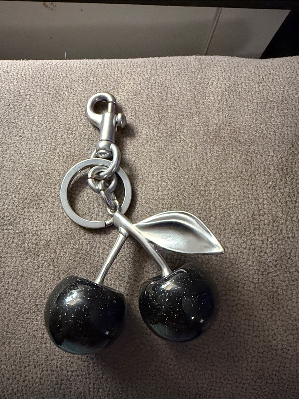 Two Cherry Keychains, Black Glitter Cherries. One silver and one gold.